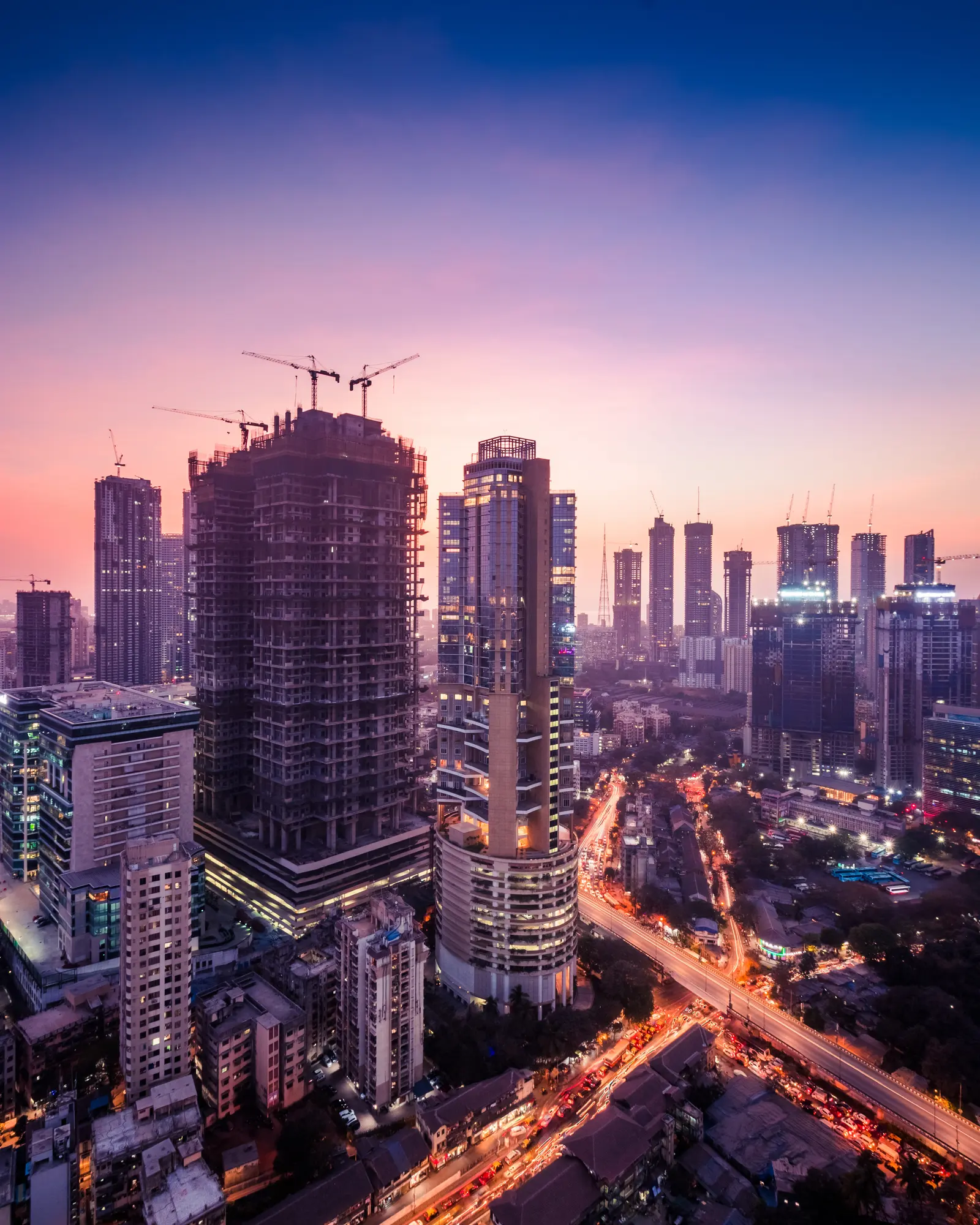 Premium residential towers under a purple twilight sky