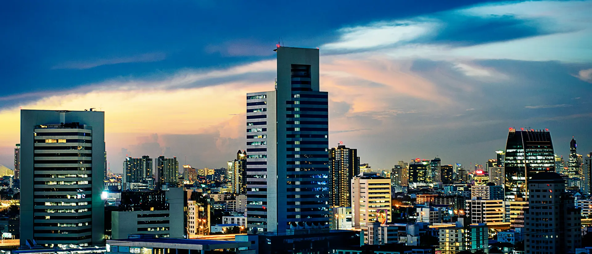 City skyline at sunset representing full-spectrum real estate services